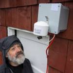 Mike Hekkers looks at an air quality measurement device that was installed by the Department of Environmental Conservation at his downtown home on Thursday, April 18, 2019. The device, along with a number of others, will measure air quality in downtown during this summers cruise ship season. (Michael Penn |Juneau Empire)