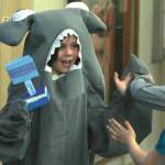 Sayeik Gastineau Elementary student Maddie Bass, dressed as a hammerhead shark, gives high-fives to other students after an assembly at the school on Thursday, May 2, 2019. The assembly was a year-end celebration for the Ocean Guardians program that promotes recycling and cutting down on plastic usage. (Alex McCarthy | Juneau Empire)