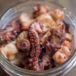 Rik Pruett said it has been a dream come true to bring his smoked octopus to market. (Michael Penn | Juneau Empire)