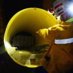Kensington Mine General Manager Mark Kiessling shows an escape tube to be used by workers in the event of an emergency on Monday, Oct. 14, 2019. (Peter Segall | Juneau Empire)