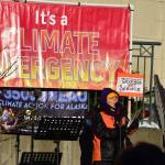 Peter Segall / Juneau Empire 
Juneau poet Lynn Davis reads a poem Tuesday at a demonstration in Dimond Court Plaza across from the Alaska State Capitol. Dozens of protestors gathered to support strong actions by the state to combat climate change.