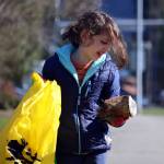 Gerald Thill, 7, inspects a weathered can before placing it in a litter bag on Saturday during the citywide cleanup. (Ben Hohenstatt / Juneau Empire)