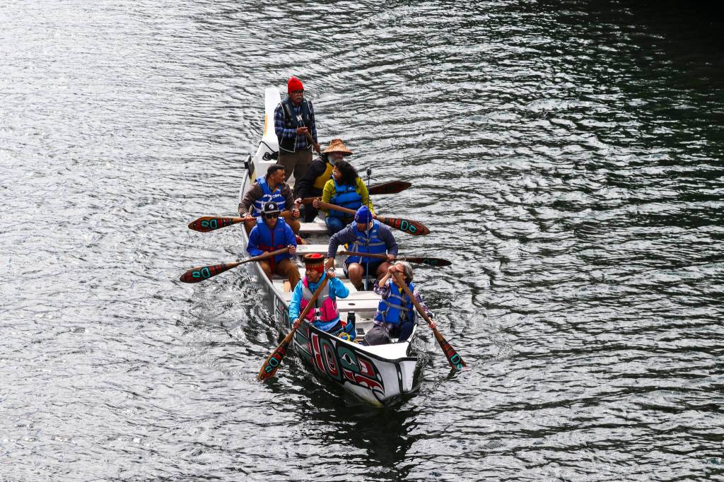 Members of One People Canoe Society paddle through Juneau harbor during the 12th Annual Maritime Festival on May 7, 2022. (Michael S. Lockett / Juneau Empire)