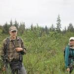 Discovery Southeast naturalist Richard Carstensen speaks to a group of hikers about the origins of the wetlands during a break on the hike. (Clarise Larson / Juneau Empire)