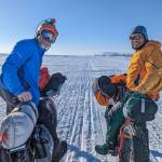 Jamie Hollingsworth, left, and Bill Fleming pause with Cape Nome in the distance, within 10 miles of the finish of their 1,000-mile ride on the Iditarod Trail. (Courtesy Photo / Jay Cable)