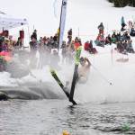 A skier makes a crash landing into the skim pond at Eaglecrest Ski Area as they partake in the return of the Slush Cup Saturday afternoon. (Clarise Larson / Juneau Empire)