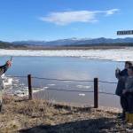 Ryan Becker, a teacher at the Eagle school, takes a photo of his students as part of a continuing Yukon River ice study on May 12, 2023. (Courtesy Photo / Ned Rozell)