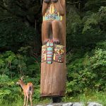 A deer wanders near the Auke Rec Totem Pole at about 15 Mile Glacier Highway on July 19. (Photo by Joe Orsi)