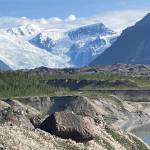 From left, Martin Truffer and Adam Bucki walk along the gravel moraine of Kennicott Glacier on an 11-hour hike to reach Fireweed rock glacier. (Photo by Ned Rozell)