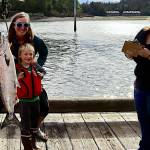 Jackie Ebert, 37, and her son William Oliver Dryer, 6, stand behind a fish he caught on Friday, the first day the 77th annual Golden North Salmon Derby, at the Auke Nu Cove weigh station. A few minutes earlier Ebert turned in a 14.2-pound fish, narrowly edging out a 14 pounder that was the heaviest at that point in the day. (Meredith Jordan / Juneau Empire)