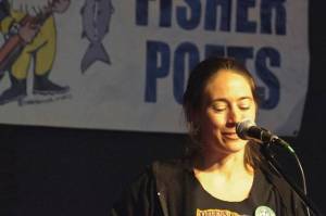 Author Tele Aadsen performing at her first FisherPoets Gathering in 2012. Her book, What Water Holds, is a collection of essays she wrote for the annual festival over the next 12 years. (Photo courtesy Pat Dixon)