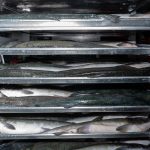 Salmon on pans, ready for freezing, at Circle Seafoods, in Metlakatla on Aug. 19, 2024. Over the last few years, the $6 billion Alaskan wild seafood market has been ensnared in a mix of geopolitics, macroeconomics, changing ocean temperatures and post-Covid whiplash that piled on top of long-building vulnerabilities in the business model. (Ash Adams/The New York Times)