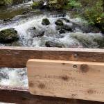 A newly installed Forest Service sign orients recreators on the reconstructed Fish Creek bridge, one of 64 bridges that were rebuilt along the 14-mile trail. (Photo by Dave Haas)