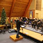 Alan Young conducts the Taku Winds brass ensemble through a rehearsal Wednesday for its upcoming holiday concerts Saturday and Sunday at K̠unéix̠ Hídi Northern Light United Church. (Mark Sabbatini / Juneau Empire)