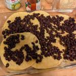 Layering beans on a tortilla casserole. (Photo by Patty Schied)