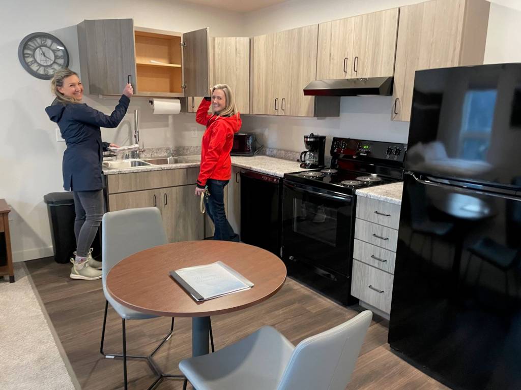 Legislative Affairs Agency Executive Director Jessica Geary and Juneau Real Estate property manager Elizabeth Clayton show off the new kitchen in a studio apartment. The building was purchased, renovated, furnished and donated to the state agency through the Juneau Capitol Fund and the nonprofit philanthropic Juneau Community Foundation. (Laurie Craig / Juneau Empire)