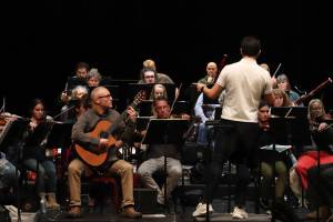The Juneau Symphony rehearses for its winter mainstage concert in the Juneau-Douglas High School: Yadaa.at Kalé auditorium on Jan. 23, 2025. (Jasz Garrett / Juneau Empire)