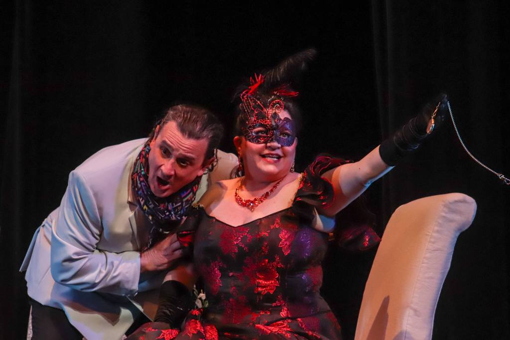 Rosalinda (Sara Radke Brown) steals her husbands watch that he claims bewitches women during a rehearsal of Die Fledermaus on Wednesday, March 12, 2025. (Jasz Garrett / Juneau Empire)