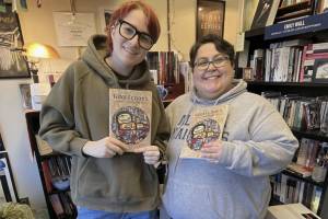 Tidal Echoes editors Annie Kessler and Adonis Scalia holding 2025 editions (Photo from @uas.tidalechoes on Instagram)