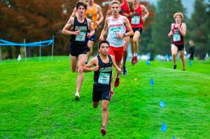 University of Alaska Anchorage freshman Edgar Vera-Alvarado (143) runs in the 2024 GNAC XC Championships on Oct. 26, 2024 at the Sudden Valley Golf Course in Bellingham, Washington. Freshman teammate Anthony Porter (138) from Colorado Springs, Colorado, runs behind. (Photo courtesy UAA)
