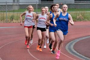 Sitkas Marina Dill leads the girls 3,200 during the Capital City Invitational on Friday. At far left is Juneau-Douglas High School: Yadaa.at Kalé freshman Sigrid Eller and junior Siena Farr. (Klas Stolpe / Juneau Empire)