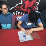 Juneau-Douglas High School: Yadaa.at Kalé senior Pedrin Saceda-Hurt signed an NCAA Division III student-athlete form on Wednesday in the JDHS commons to attend Luther College in Decorah, Iowa, and play for the Norse basketball team. At left is grandmother Gethsemane Saceda, mother Nickie Saceda-Hurt and at right is father Frank Hurt. (Klas Stolpe/Juneau Empire)