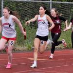 Juneau-Douglas High School: Yadaa.at Kalé freshman Addie Hartman takes the baton from classmate Shandiin Frommherz in the girls 4x100 relay during the Region V Track & Field Championships at Juneaus Thunder Mountain Middle School on Friday. (Klas Stolpe / Juneau Empire)