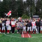 The Juneau-Douglas High School: Yadaa.at Kalé Crimson Bears softball seniors and family members pose for a photo Saturday at Adair-Kennedy Memorial Park during senior honors. (Klas Stolpe / Juneau Empire)