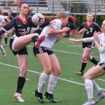 Juneau-Douglas High School: Yadaa.at Kalé senior Ella Orsborn (9) wins a ball against Wasilla as senior teammate Adelyn Buss (3) moves in during the Crimson Bears senior appreciation game Saturday at Adair-Kennedy Memorial Park. (Klas Stolpe / Juneau Empire)