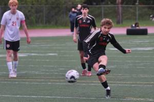 Juneau-Douglas High School: Yadaa.at Kalé senior Kai Ciambor hits a penalty kick to break the Crimson Bears career scoring record during Saturdays Crimson Bears senior appreciation game at Adair-Kennedy Memorial Park. (Klas Stolpe / Juneau Empire)