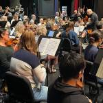 Tigran Arakelyan leads the Juneau Symphony through a rehearsal on Thursday, May 29, 2025, in the Juneau-Douglas High School: Yadaa.at Kalé auditorium. He is among four candidates seeking to become the symphonys new music director. (Mark Sabbatini / Juneau Empire)