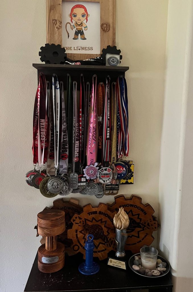 Chrish Newells multitude of awards for her strength endurance obstacle races. (Photo courtesy Chrish Newell)