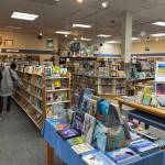 People browse at the Hearthside Books branch in the Nugget Mall on Monday, May 26, 2025. (Mark Sabbatini / Juneau Empire)