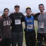 Snow Doubts Trinity Jackson, Ricardo Worl, Finley Hightower and Justin Sleppy at the finish line of the Seacoast Relay at the Eagle Beach State Park outer beach picnic shelter on Sunday, June 8, 2025. (Klas Stolpe / Juneau Empire)