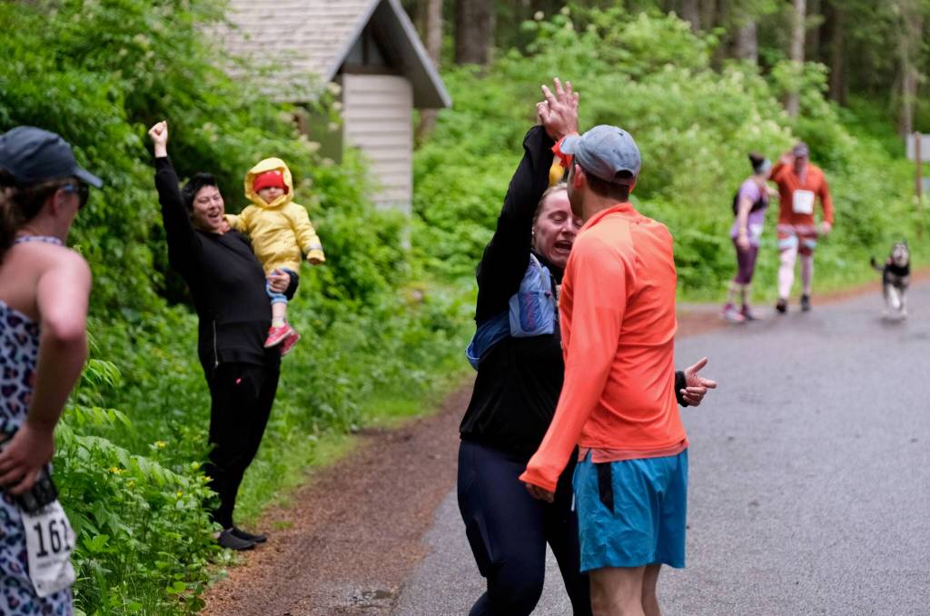 Team Four Moms, One Dad make a hand off at Lena Beach Picnic Area during the Seacoast Relay on Sunday, June 8, 2025. (Klas Stolpe / Juneau Empire)