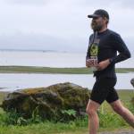The Stragglers Eric Antrim approaches the finish line of the Seacoast Relay at the Eagle Beach State Park outer beach picnic shelter on Sunday, June 8, 2025. (Klas Stolpe / Juneau Empire)