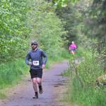Troy Stallings approaches the finish of the East Glacier Trail Tangle on Tuesday. The 4.9-mile race follows part of Under Thunder Trail around East Glacier Trail and back. (Klas Stolpe / Juneau Empire)