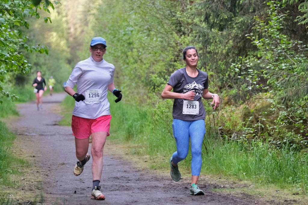 Becky Bohrer and Danielle Dunivin approach the finish of the East Glacier Trail Tangle on Tuesday. The 4.9-mile race follows part of Under Thunder Trail around East Glacier Trail and back. (Klas Stolpe / Juneau Empire)