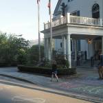Families write messages in chalk outside the governor's mansion on Friday, June 13, 2025. (Natalie Buttner / Juneau Empire)