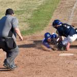 Xzavier Martin of Madisonville (Kentucky) Post 6 scores against Noah Lewis of Auke Bay Post 25 on Friday, June 20, 2025, in the Lance Coz Wood Bat Tournament at Coral Seymour Memorial Park in Kenai, Alaska. (Photo by Jeff Helminiak/Peninsula Clarion)
