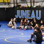 2024 Olympic wrestling gold medalist Amit Elor, 21, talks to camp wrestlers during the Juneau Girls Wrestling Clinic on Tuesday at the Juneau Wrestling Center. (Klas Stolpe / Juneau Empire)
