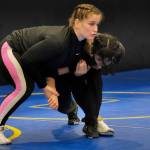 2024 Olympic wrestling gold medalist Amit Elor, 21, center, demonstrates a counter move on JDHS sophomore Toriana Johnson, 15, during the Juneau Girls Wrestling Clinic on Tuesday at the Juneau Wrestling Center. (Klas Stolpe / Juneau Empire)