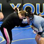 2024 Olympic wrestling gold medalist Amit Elor, 21, center, demonstrates a counter move on 2025 Colony High School graduate, and state champion, Amelia Fawcett, 18, during the Juneau Girls Wrestling Clinic on Tuesday at the Juneau Wrestling Center. (Klas Stolpe / Juneau Empire)