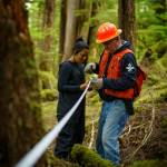 Bob Girt works with youth on Prince of Wales Island in 2022, and gives instructions on how to take forestry measurements. (Photo courtesy of Bethany Goodrich / Sustainable Southeast Partnership)