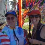 Attendees smile for a photo in between being bedazzled on Friday, Aug. 2, during the 2025 Salmonfest at Kenai Peninsula Fairgrounds. (Chloe Pleznac/Homer News)
