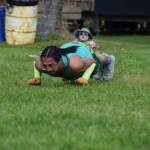 Fairbankss Trevor Edwards demonstrates a knuckle seal hop while a curious clown looks on during Salmonfest 2025 on Friday, Aug. 2, at the Kenai Peninsula Fairgrounds in Ninilchik. (Chloe Pleznac/Homer News)