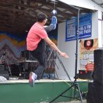 Dez Hess performs the 1-foot high kick during a Native Youth Olympics demonstration at the Inlet Stage on Saturday, Aug. 2, 2025, at the Kenai Peninsula Fairgrounds in Ninilchik, Alaska. (Delcenia Cosman/Homer News)
