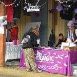 Salmonfest attendees visit advocacy booths in the Causeway, including the Abused Womens Aid in Crisis, Inc., on Saturday, Aug. 2, 2025, at the Kenai Peninsula Fairgrounds in Ninilchik, Alaska. (Delcenia Cosman/Homer News)