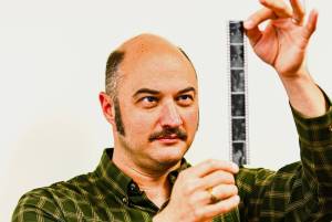 James Edens looks at 35mm film he had just developed. Photo by By Jonathon Dawe/ Wrangell Sentinel)