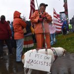 One dog at the No Tsars, No Kings wears a sign that says, I Pee on Fascists! (Mari Kanagy/Juneau Empire)